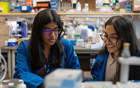 Lu lab members and the study's co-first authors Isha Mondal and Oishika Das sitting a lab bench