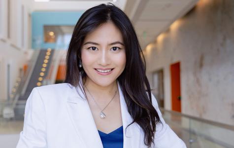Rongze "Olivia" Lu, PhD, stands in the hallway on the 4th floor of the Helen Diller Family Cancer Research Building.